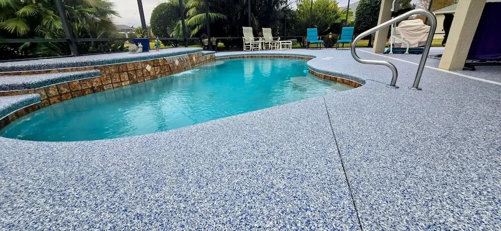 Blue and white flake coating on a pool deck