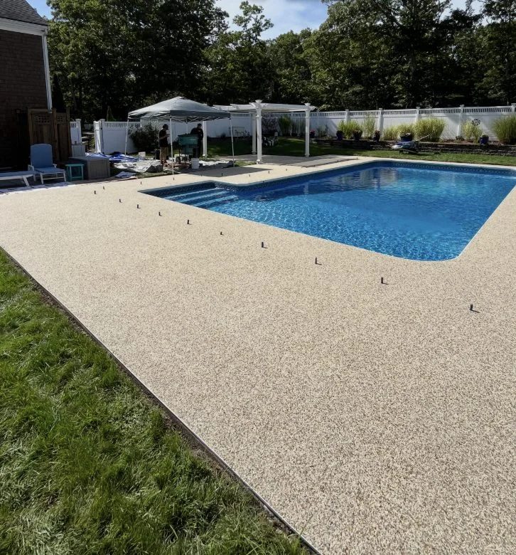 Tan flake coating around an in-ground pool