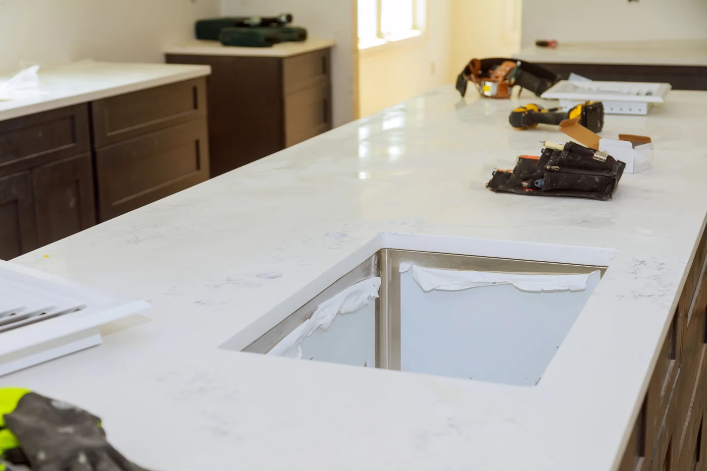 New white quartz countertop with undermount sink cutout during installation